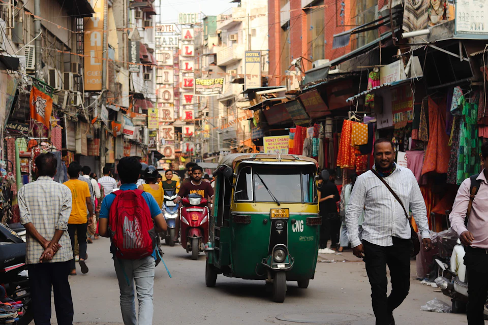 People walking down a busy market street