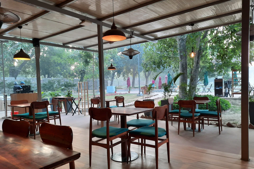 Restaurant with wooden tables and green cushions
