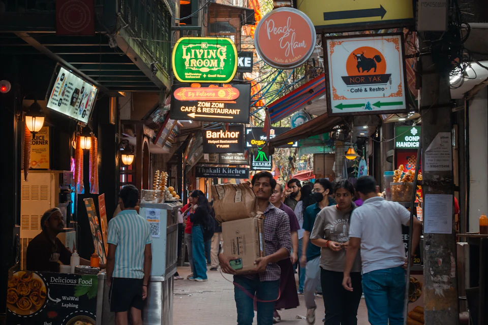 Crowded street market with shop signs