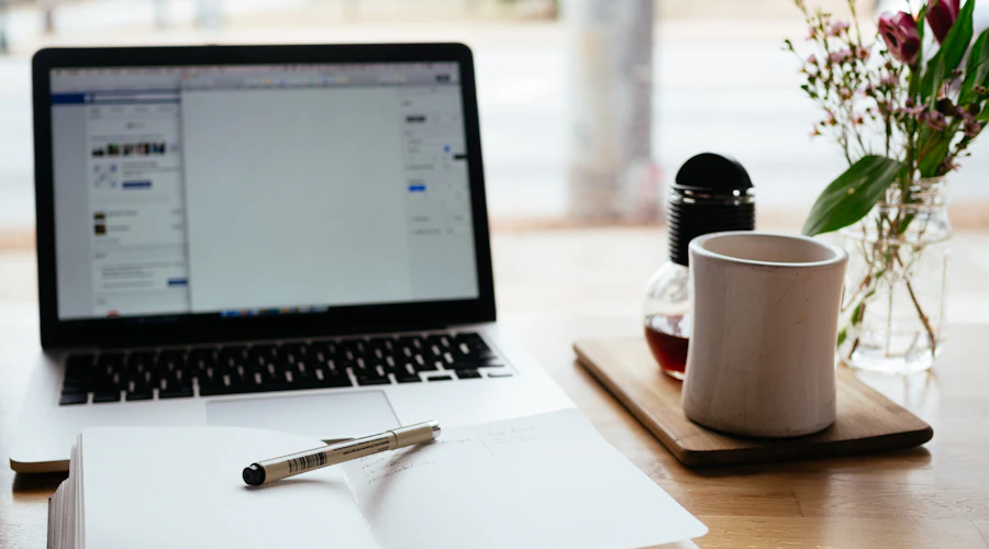 Laptop and notebook on a desk, ready for a free consultation