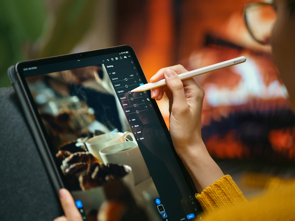 Designer editing an image with a digital pen and tablet