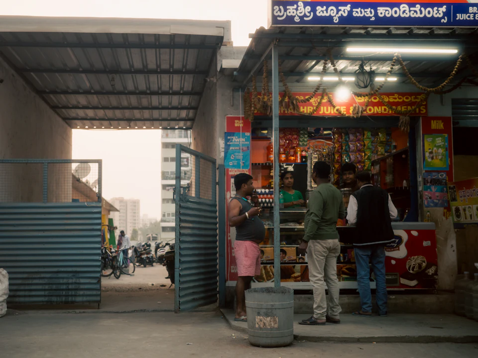 People gathered outside a small local shop in India