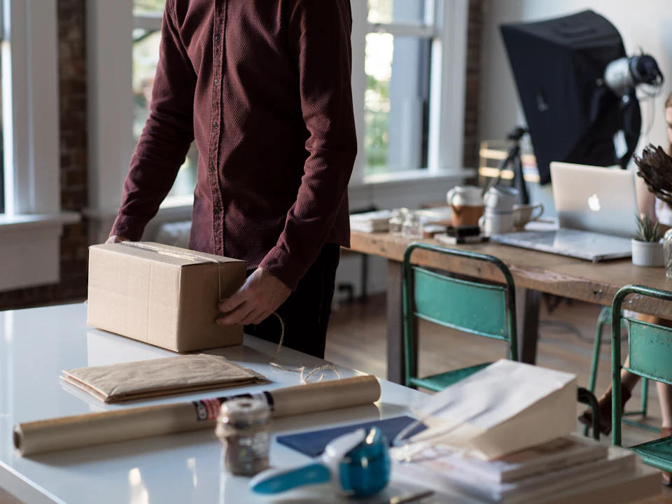 Packing an online order into a cardboard box